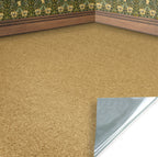 Close-up of a textured beige brown peel and stick dolls house floor covering with a corner and part of a white wall visible.
